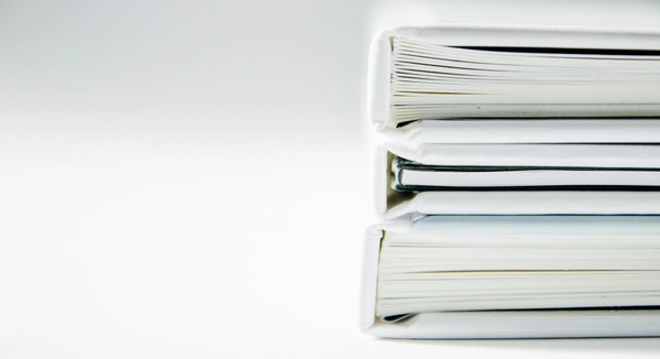 Stack of organized document folders representing structured document management